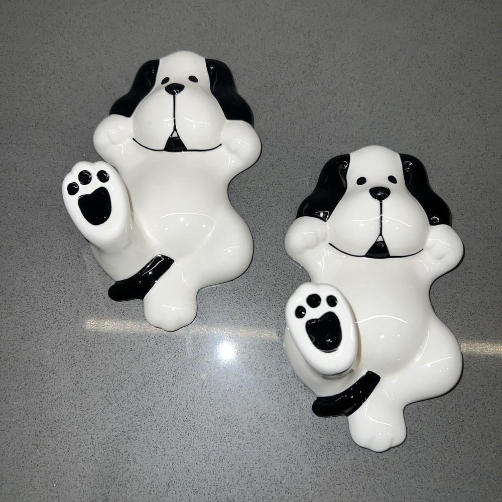 Two black-and-white dog wall hooks